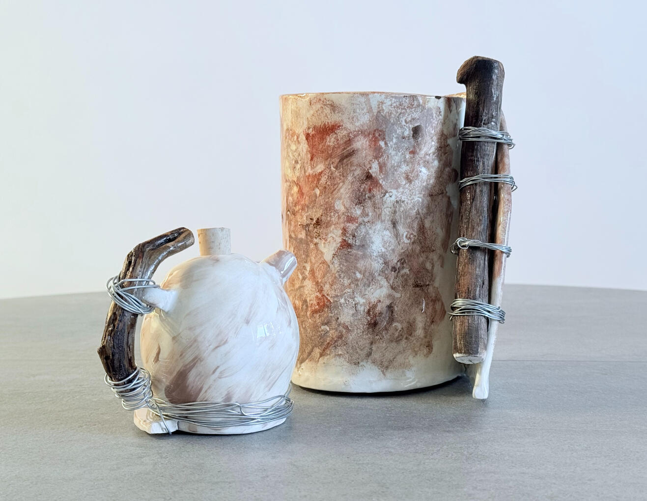 Vase and oil pot inspired by nature. Ceramic sculpture with wood.